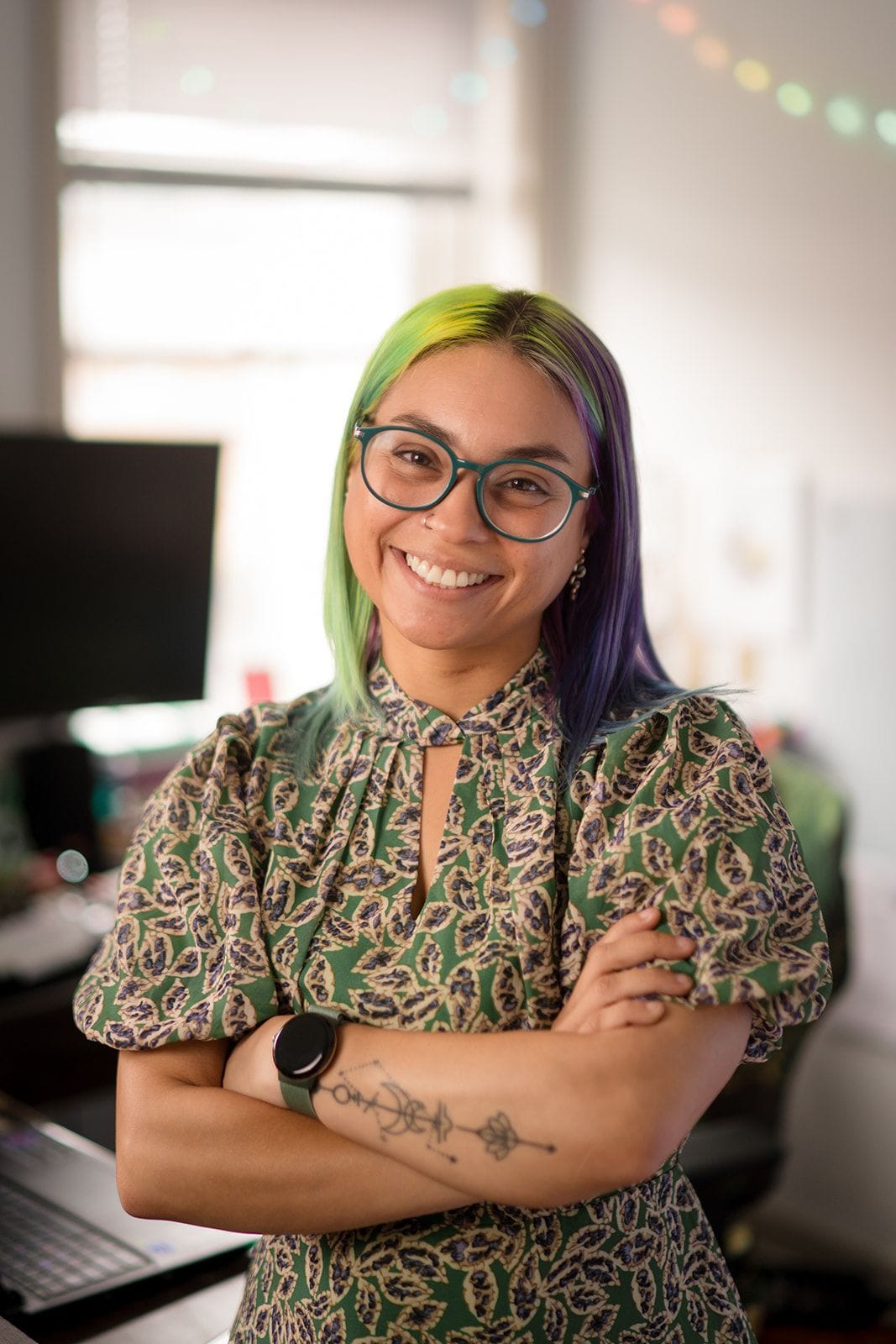 Joa Garcia, owner of Prism Consulting, crossing her arms and smiling for a headshot
